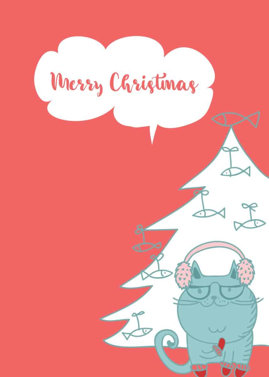 cat with headphones standing front of a Christmas tree. The printable card says merry Christmas.